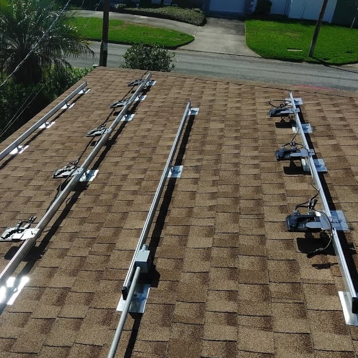 Enphase microinverters mounted beneath rooftop solar panels